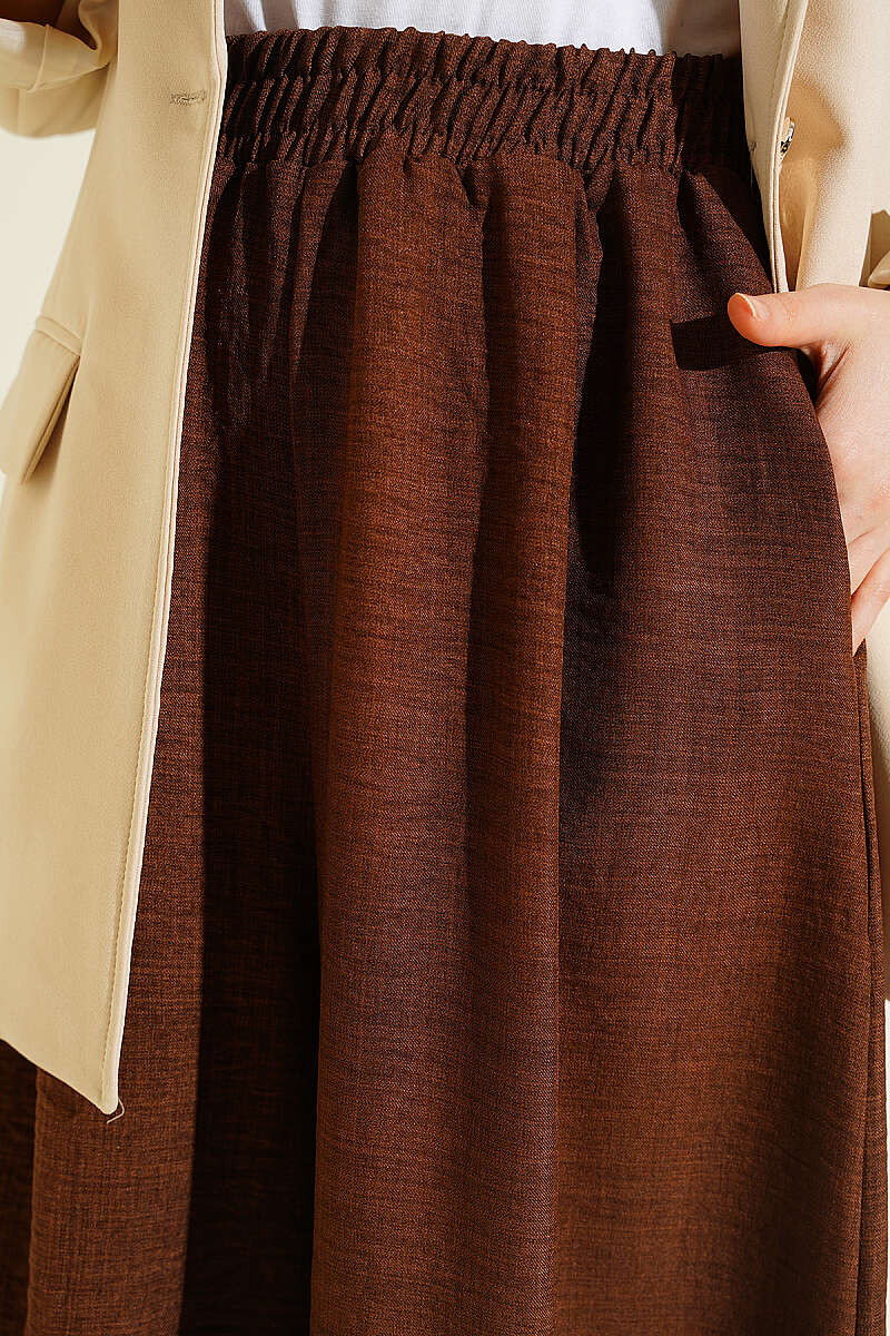 https://cdn.pazarium.com.tr/beli-lastikli-oversize-pacali-pantolon-kahve-763877-18-B.jpg