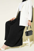 https://cdn.pazarium.com.tr/beli-lastikli-oversize-pacali-pantolon-siyah-763861-18-B.jpg