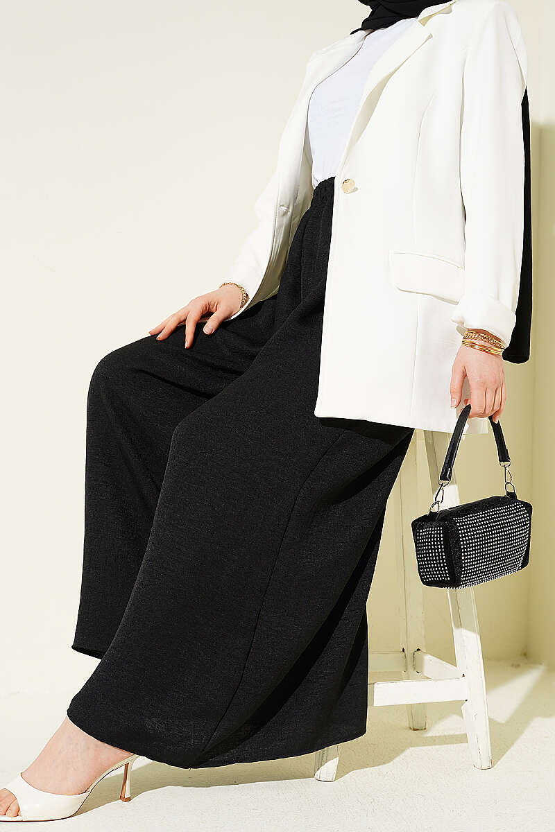 https://cdn.pazarium.com.tr/beli-lastikli-oversize-pacali-pantolon-siyah-763861-18-B.jpg