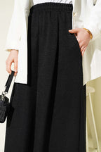 https://cdn.pazarium.com.tr/beli-lastikli-oversize-pacali-pantolon-siyah-763868-18-B.jpg