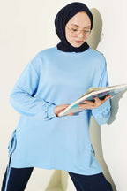 https://cdn.pazarium.com.tr/bisiklet-yaka-yanlari-ip-baglamali-tunik-bebe-mavi-756293-18-B.jpg
