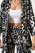 https://cdn.pazarium.com.tr/desenli-sortlu-burumcuk-kimono-takim-siyah-624183-15-B.jpg