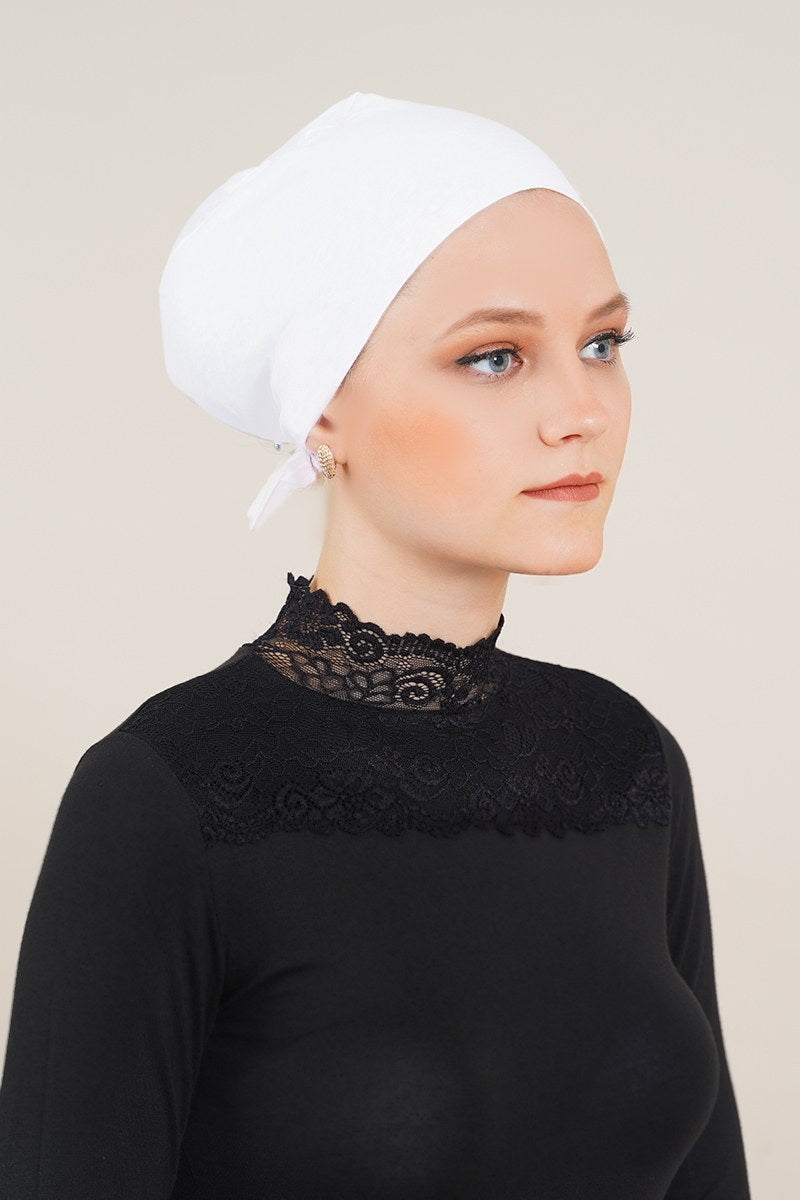 https://cdn.pazarium.com.tr/dikissiz-model-beyaz-bone-246618-42-B.jpg