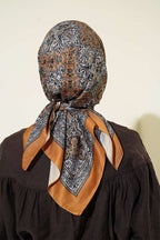https://cdn.pazarium.com.tr/otantik-motifli-esarp-camel-800909-19-B.jpg