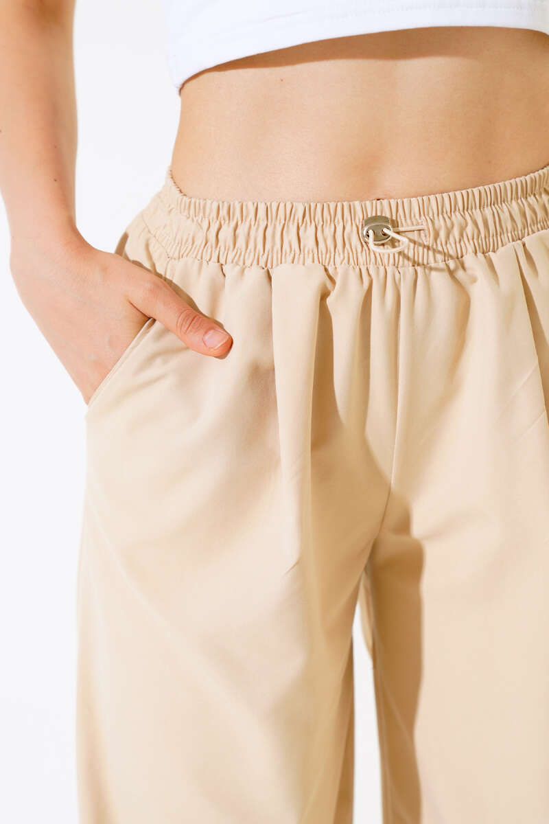 https://cdn.pazarium.com.tr/paca-lastikli-pantolon-latte-516115-12-B.jpg