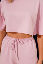 https://cdn.pazarium.com.tr/yarasa-kollu-sortlu-crop-takim-pembe-803974-19-B.jpg